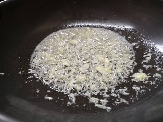 Fry garlic paste till it leaves a nice aroma for pav bhaji