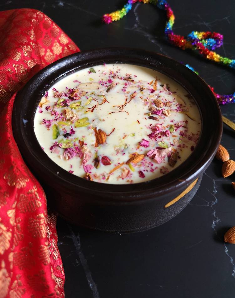 close up view of paneer kheer loaded with almonds, pistachios, dry rose petals and saffron strands, how to make Paneer Kheer for Vrat