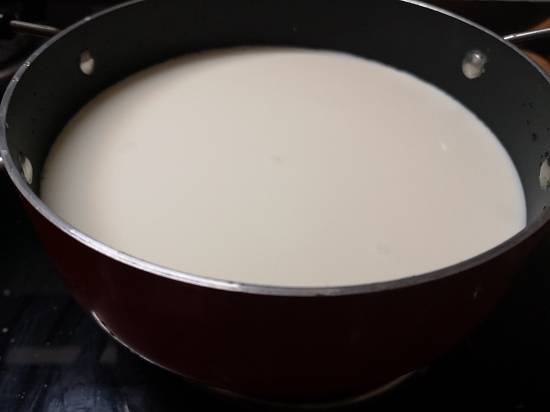 boiling milk in a heavy bottom pan for paneer payassam, kesar paneer kheer