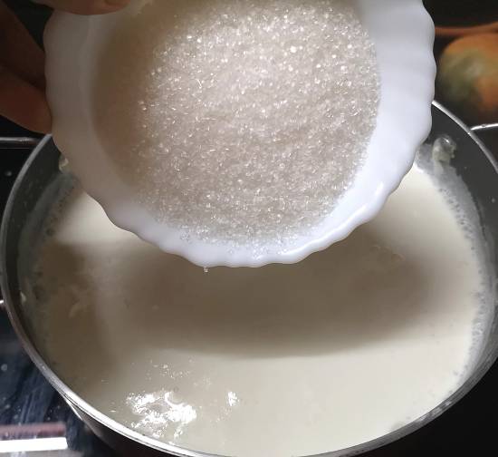 adding sugar in boiled milk and paneer for panner payasam recipe