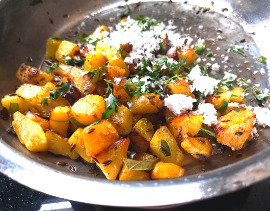 pumpkin sabzi cooked and garnished with fresh coconut and finely chopped coriander leaves