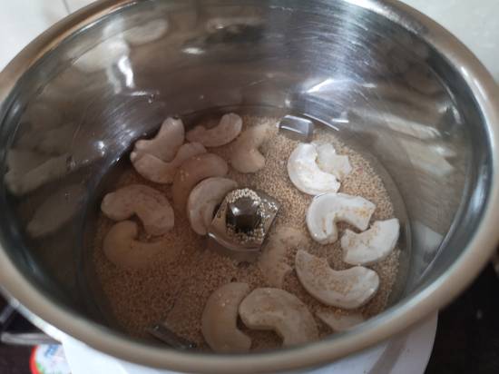 grinding cashew nuts and poppy seeds into a blender