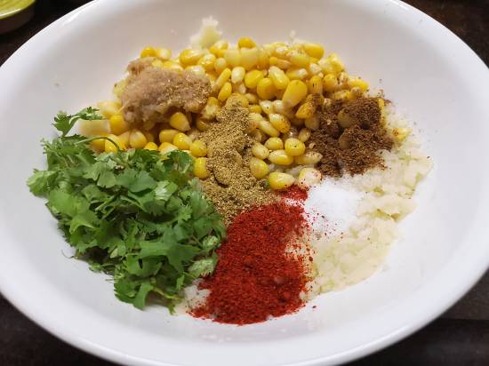 adding spices to sweet corn tikkis recipe