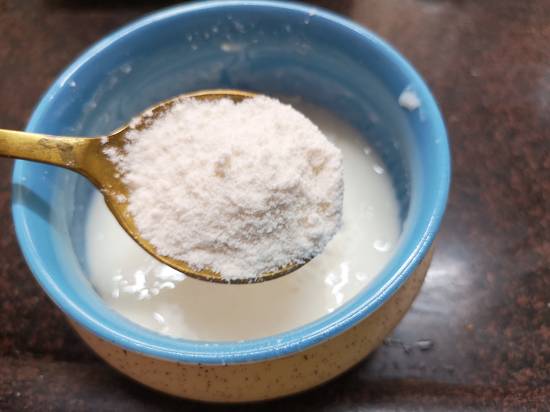 adding rajgira flour to the yogurt for aloo ki sabzi