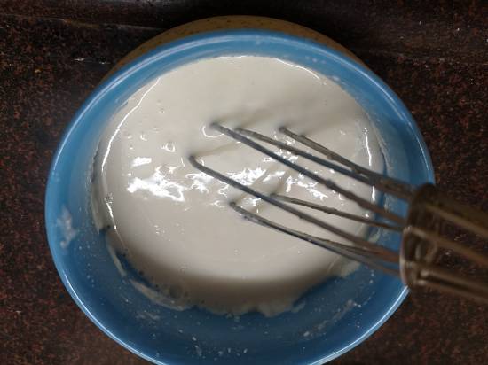 whisking yogurt and rajgira flour for aloo ki sabzi