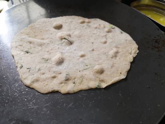 light bubbles on the kuttu parathas, being cooked on a Iron Griddle