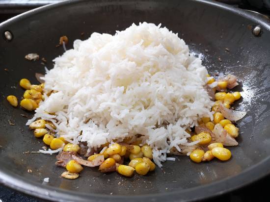 adding boiled rice to sweet corn rice recipe
