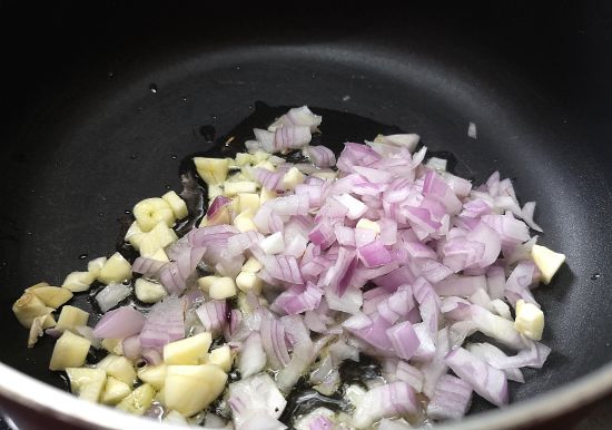 sauteing onion and garlic for Carrot and peas fritters