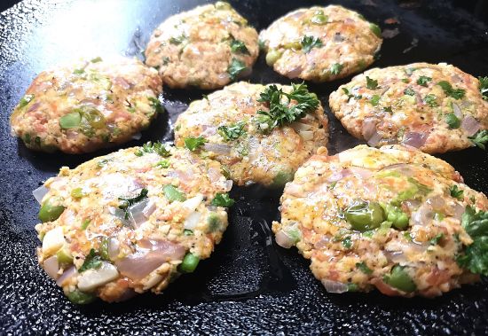 close up view of carrot and peas fritters being shallow fried in a pan, Carrot recipe to prevent cancer