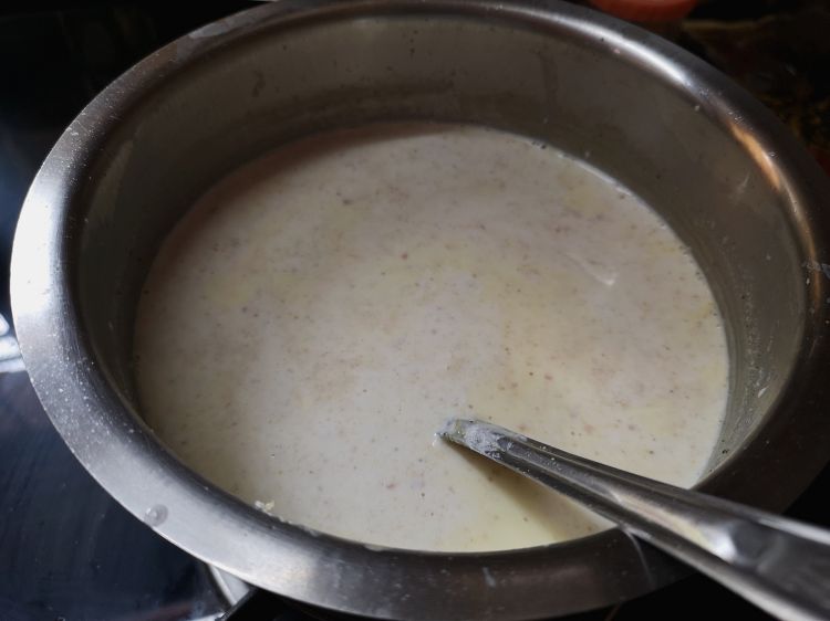 simmering milk with kesar for kesar badam doodh, saffron almond milk recipe, benefits of almond saffron milk