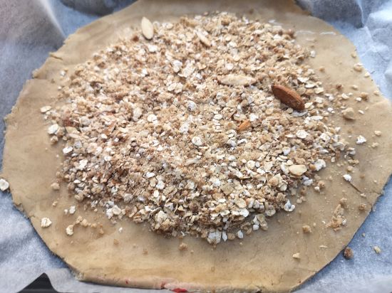 First layer of Oats Crumble spread on the galette dough