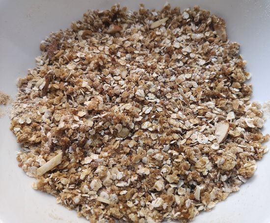 close up look of oats, wheat flour, organic jaggery powder, almonds, cinnamon powder for preparing oats crumble