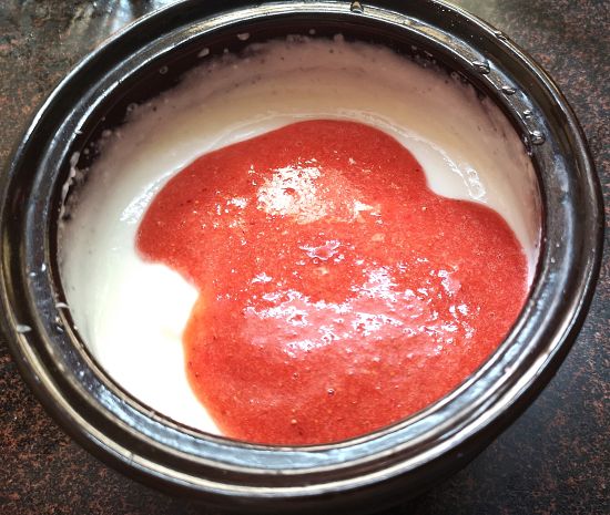mixing yogurt and strawberry puree 