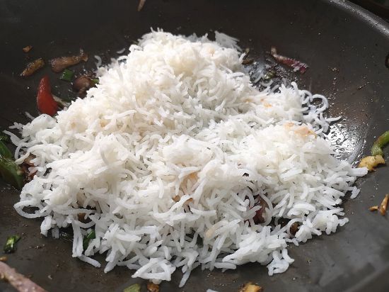 adding cooked basmati rice to the cooked mushroom 