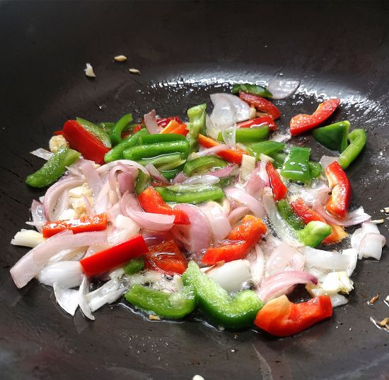 adding onions, red bell pepper, green bell pepper to the oil