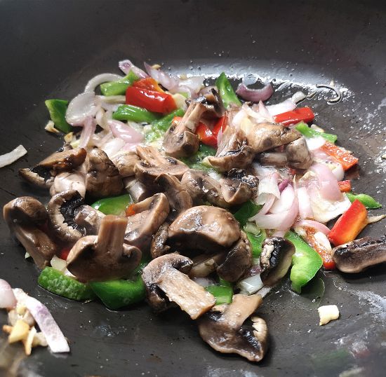 adding mushrooms to the pan