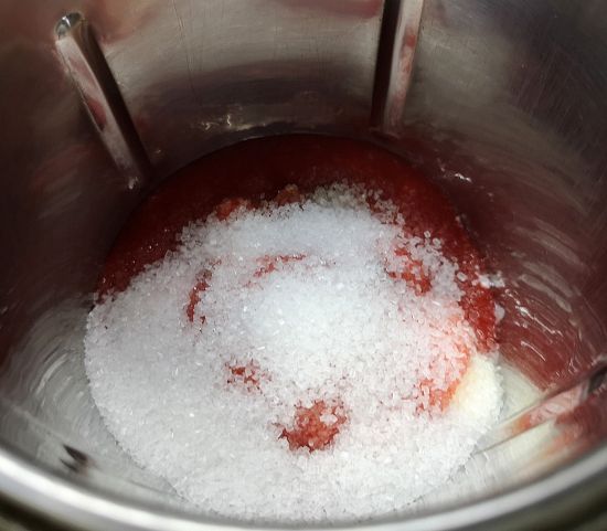 adding sugar to the blender for strawberry lassi recipe