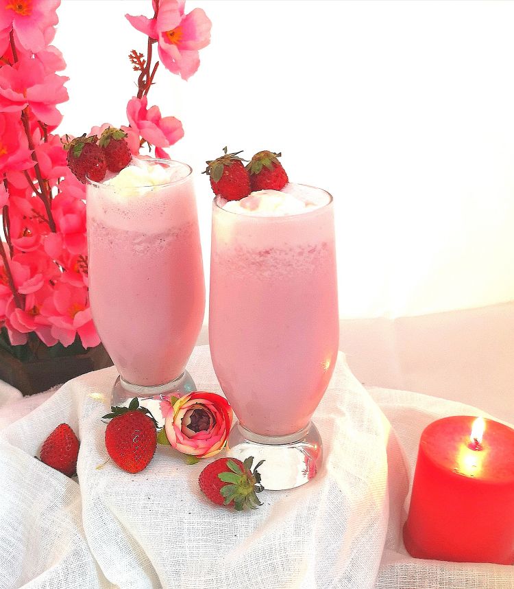 frothy, creamy strawberry milkshake, topped with fresh strawberries 