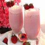 close up view of creamy and frothy Strawberry Milkshake served into 2 glasses and topped with fresh strawberries, How to make Strawberry Milkshake