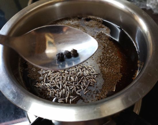 adding peppercorns for hajmola chai