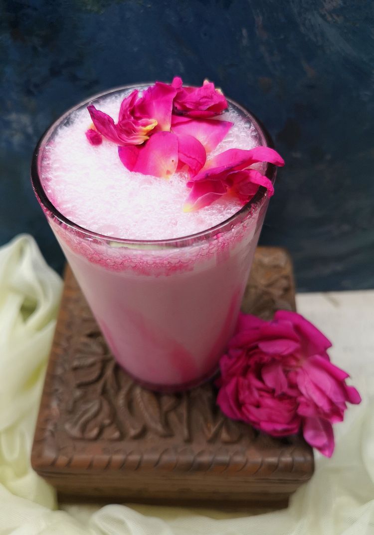 top view of tempting rose milkshake recipe topped with rose petals