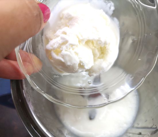 adding vanilla ice cream into the blender for Rose Milkshake Recipe