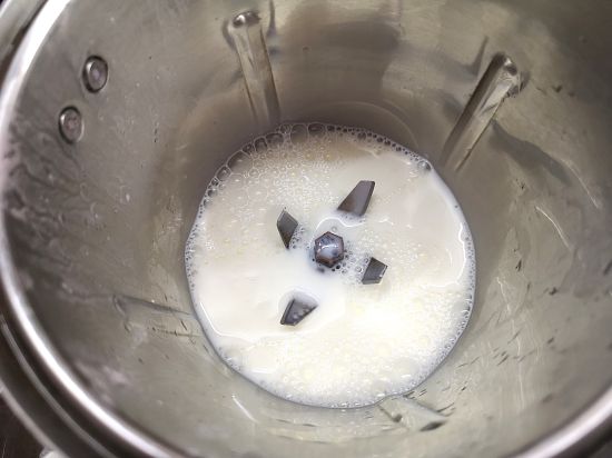 adding milk into the blender for Rose Milkshake Recipe
