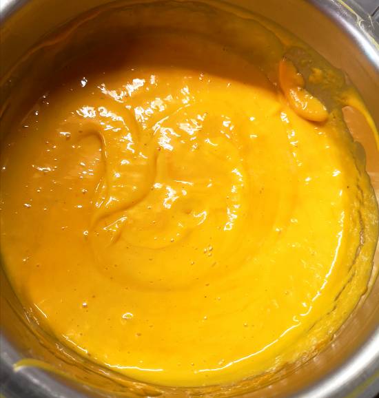 close up look of mango matka kulfi, ready to be poured into matkas