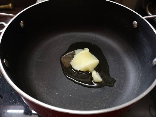 heating ghee in a pan for puran poli