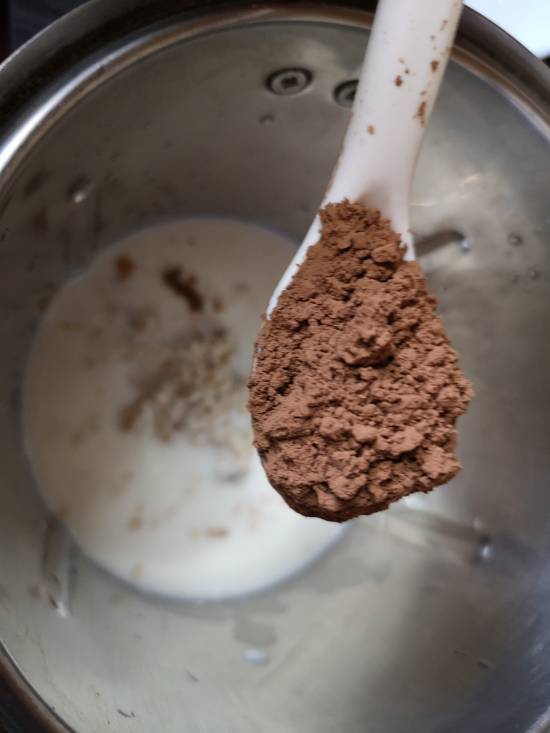 adding cocoa powder to chocolate smoothie