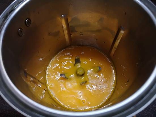 adding mango juice to the blender for Mango Turmeric Smoothie