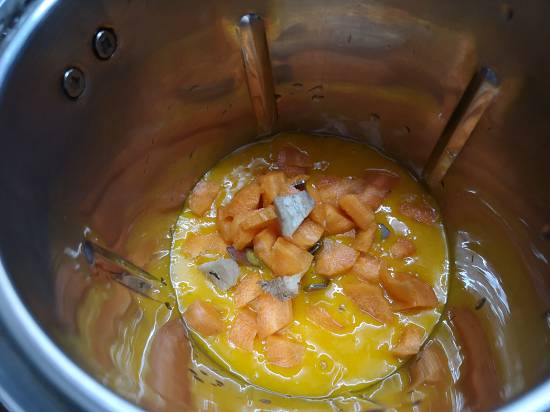 Adding carrot pieces to the blender for Mango Turmeric Smoothie