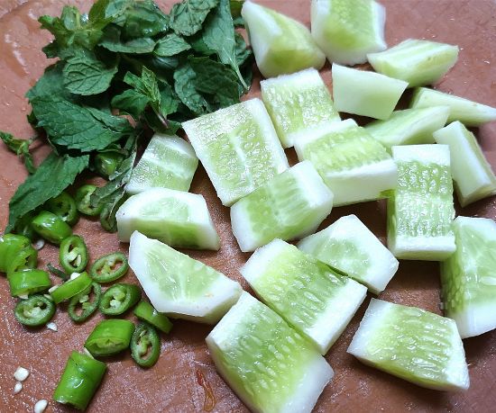 cut cucombers, chopped green chilies and mint leaves for cucumber watermelon salad