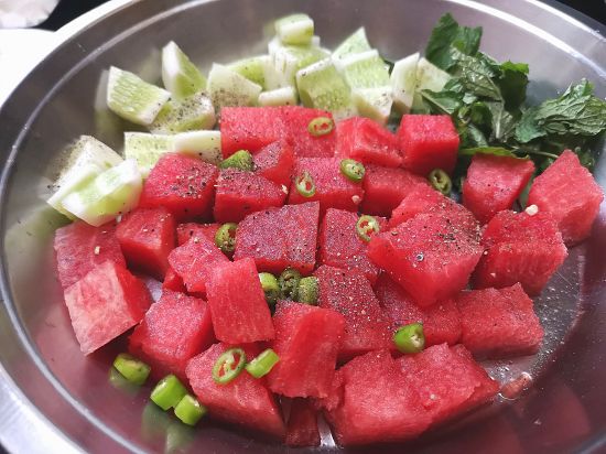 mixing watermelon chunks, cucumber chunks , mint leaves, green chilies, black pepper powder into a bowl